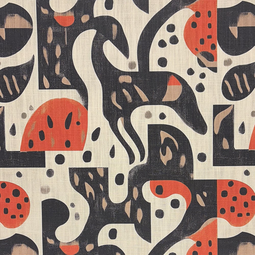 A designer upholstery fabric featuring a bold abstract pattern with organic shapes and animal-inspired silhouettes in black, beige, and red.