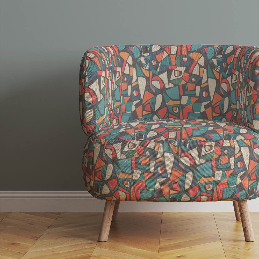 Chair view of Collage No.9 upholstery fabric in bright multicoloured design with overlapping collage pattern