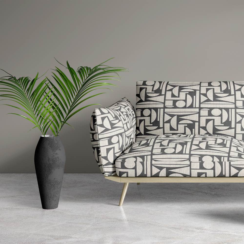 Sofa view of Cubism No.12 upholstery fabric in black and neutral with Cubism art movement design