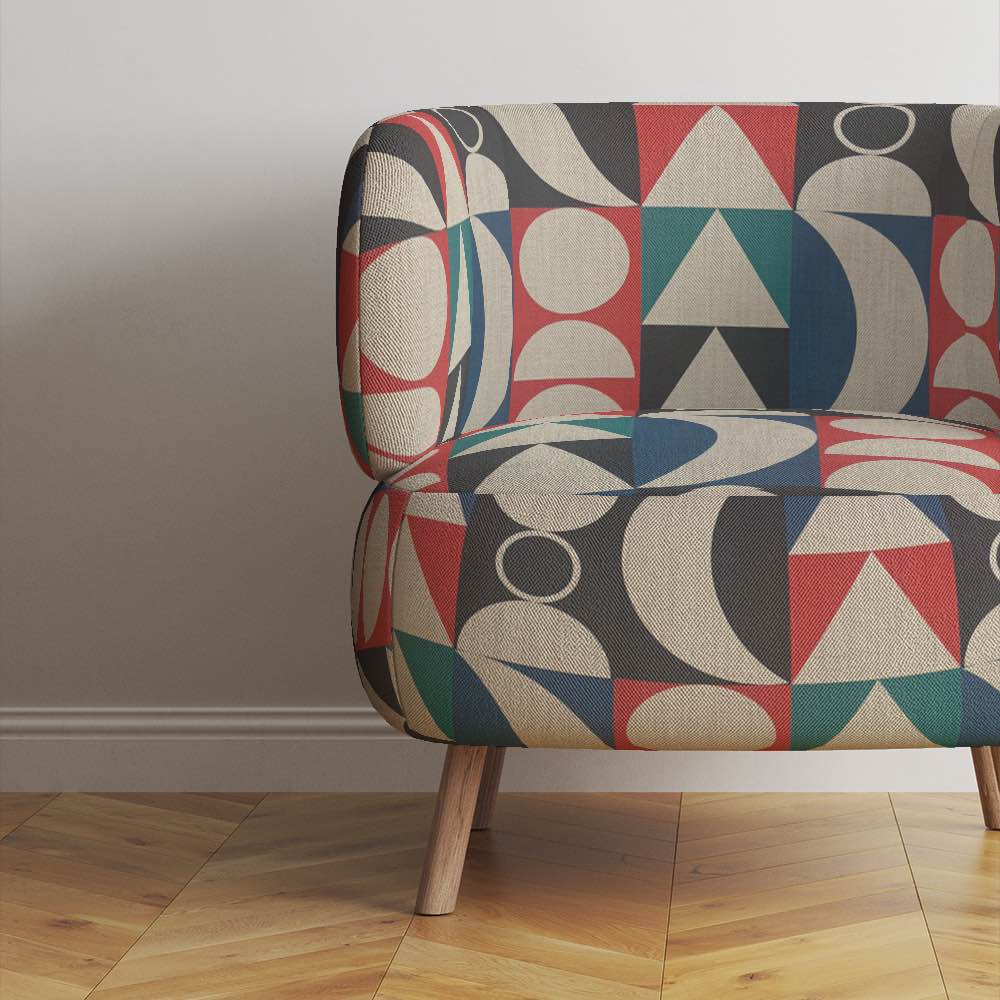 Chair view of Cubism No.19 upholstery fabric in blue, red, and neutral with Cubism art movement design