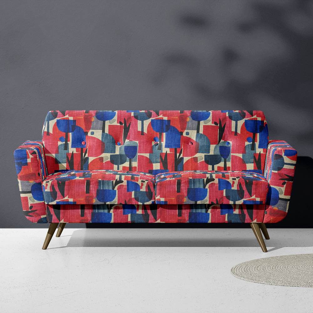 Upholstered view of Dimension No.3 upholstery fabric in pinks and blues with overlapping geometric shapes