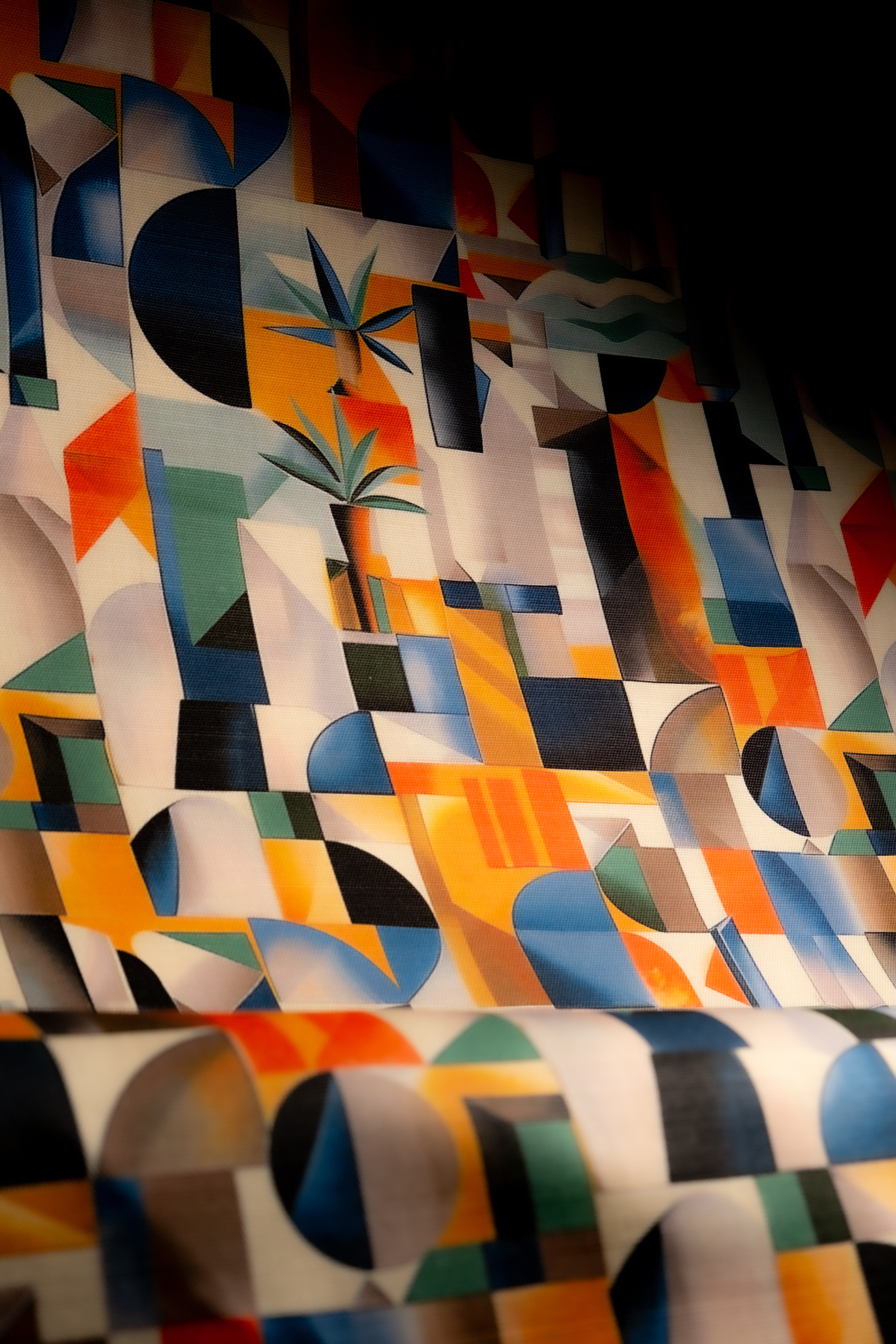 Exhibite No.16 upholstery fabric featuring bold cubist-inspired abstract patterns in vibrant orange, blue, and green tones for statement furniture.