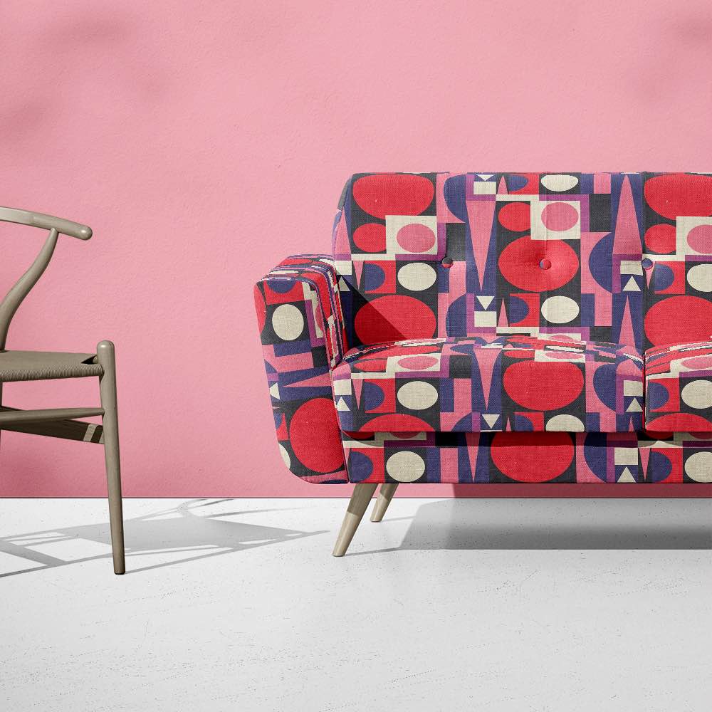 Upholstered view of Malaga No.18 pink, purple, and red upholstery fabric with Cubism art-inspired design