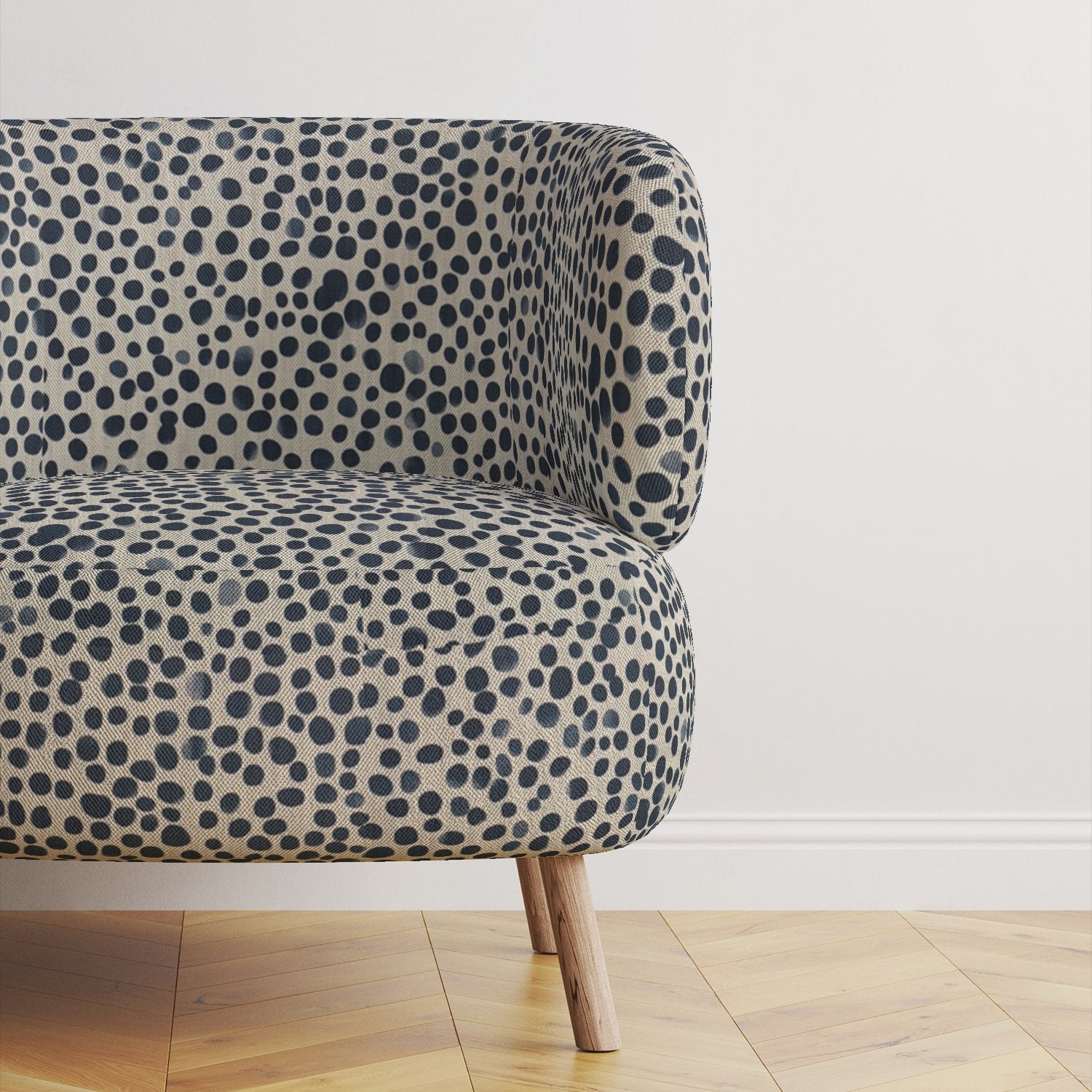 Modern upholstered sofa covered in Pointillia No.4 fabric, showcasing its deep navy tones and artistic pattern.