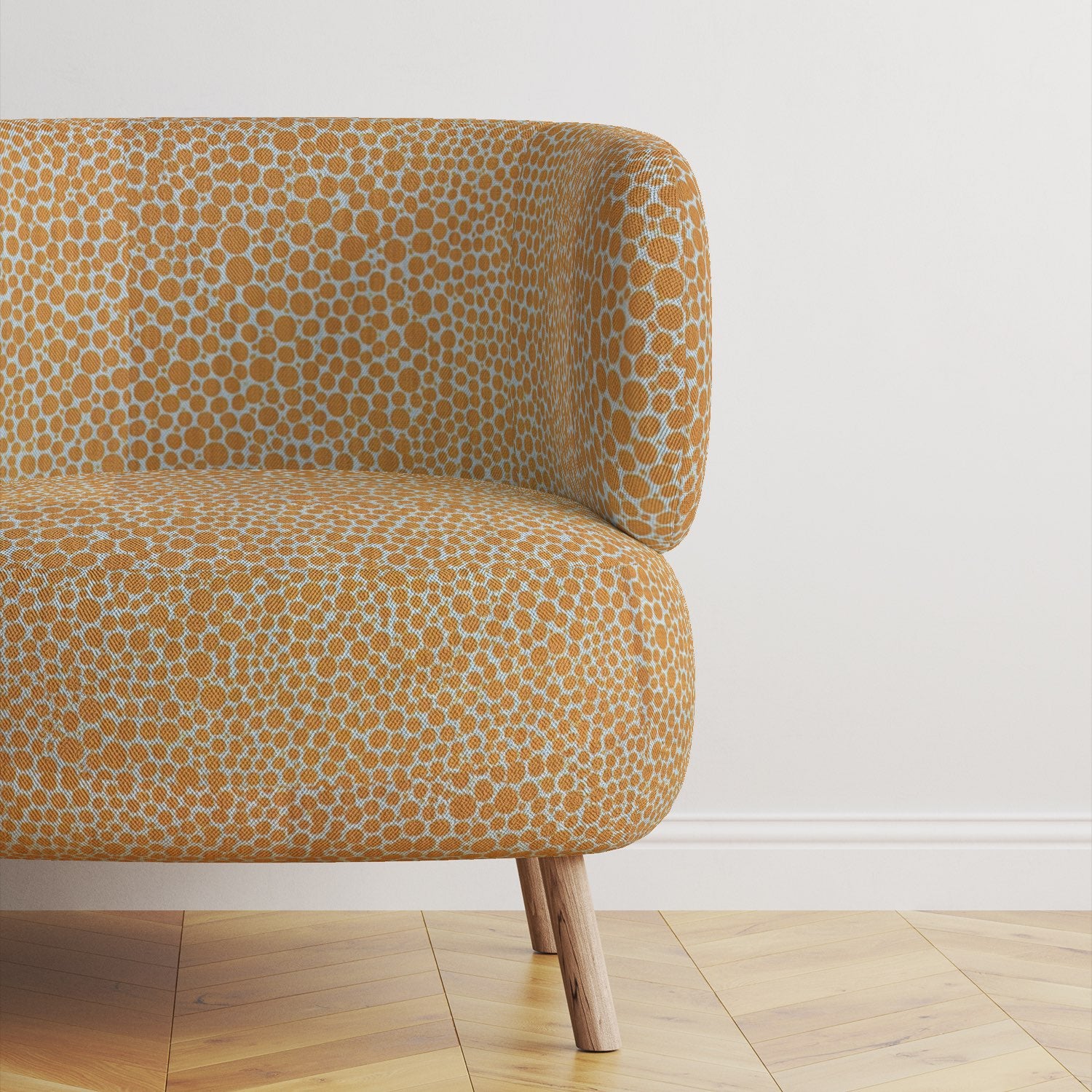 Modern upholstered chair covered in Pointillia No.5 fabric, showcasing its warm ochre tones and intricate pattern.