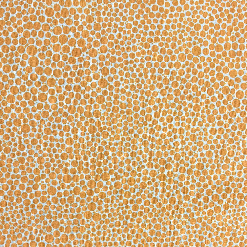 Close-up of Pointillia No.5 printed upholstery fabric featuring a golden ochre dot pattern on a linen-blend weave.