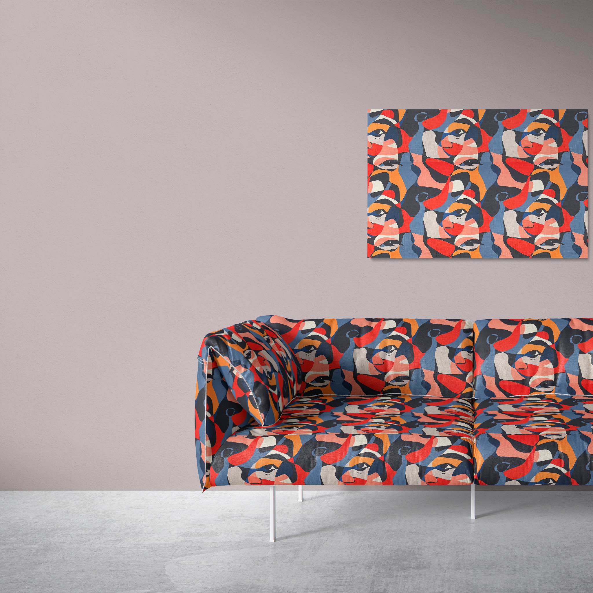 Modern sofa upholstered in Sculpture No.10 luxury fabric showcasing a striking abstract face design in colorful red, orange, and blue tones.